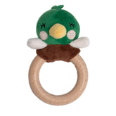 Green plush toy with a wooden ring on a white background