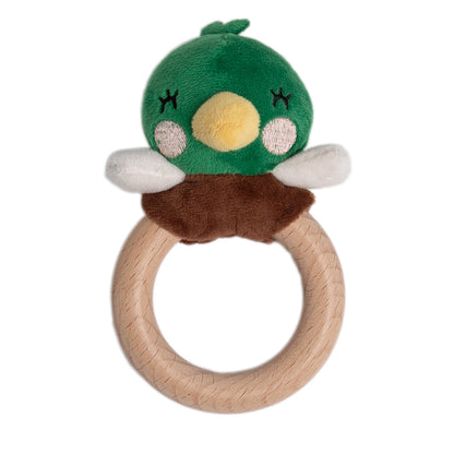Green plush toy with a wooden ring on a white background