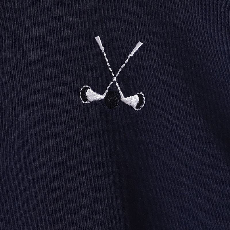 Embroidered design of two crossed golf clubs on a black background