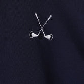 Embroidered design of two crossed golf clubs on a black background