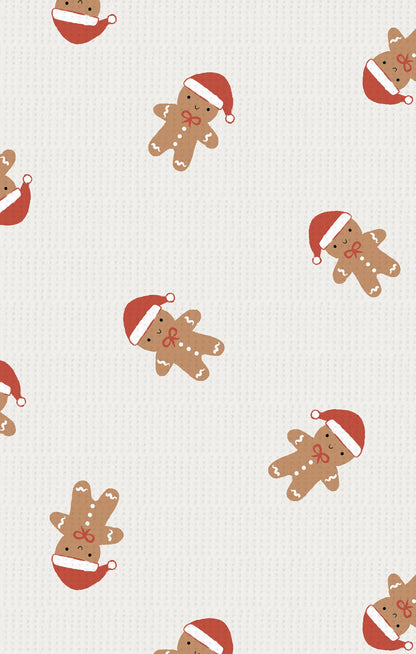 Pattern of gingerbread men with red hats on a white background