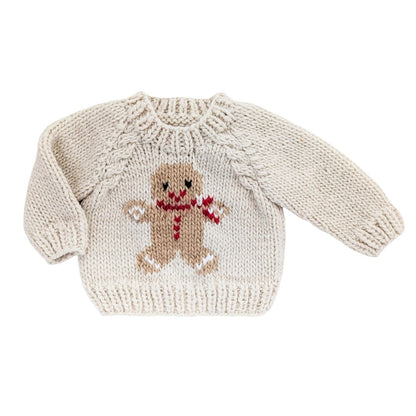 Knitted sweater with a gingerbread man design on a white background