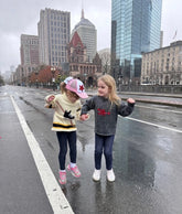two girls wearing red wagon sweaters in boston