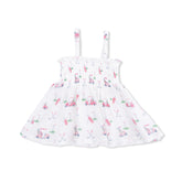 White dress with pink golf pattern on a white background