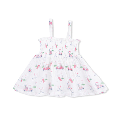 White dress with pink golf pattern on a white background