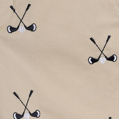 Beige fabric with embroidered black and white golf club and ball pattern