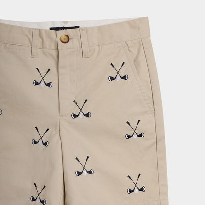 Beige pants with golf club pattern on a white background