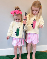 girls wearing  golf sweaters