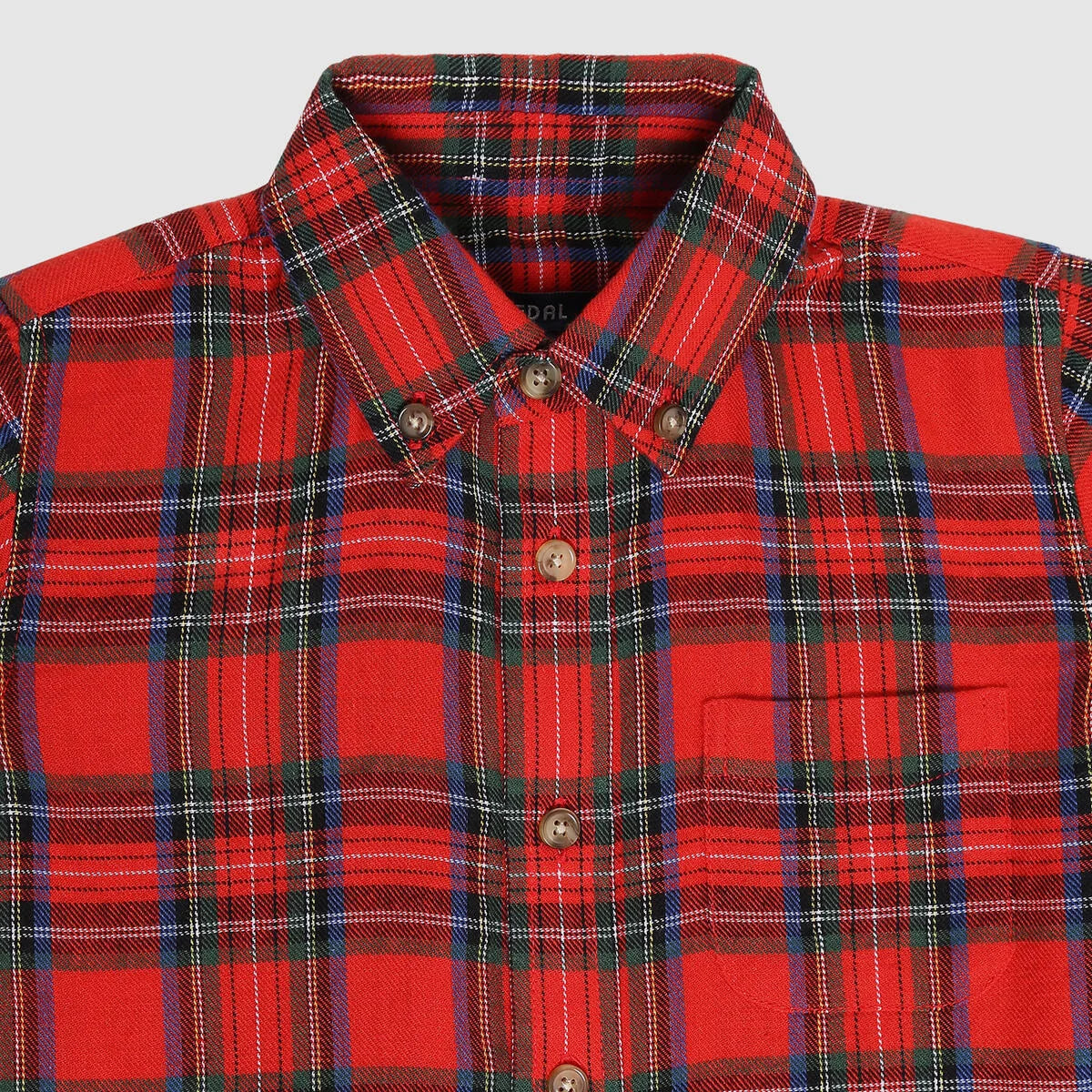 Red plaid shirt with buttons on a light gray background