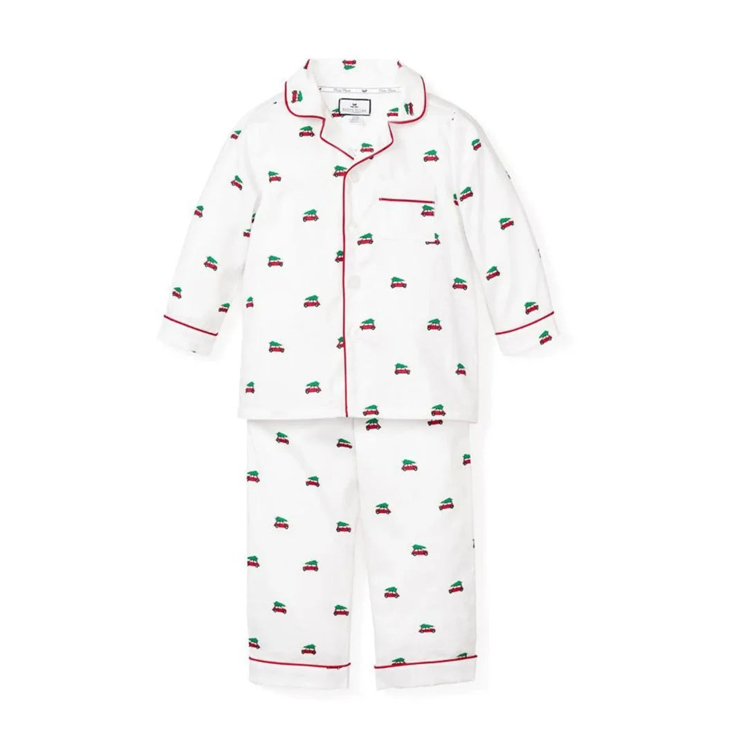 white pajamas with red trim and designs of red cars with trees on top