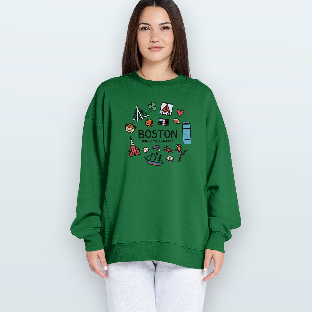 A woman modeling a green crewneck sweatshirt with a colorful &