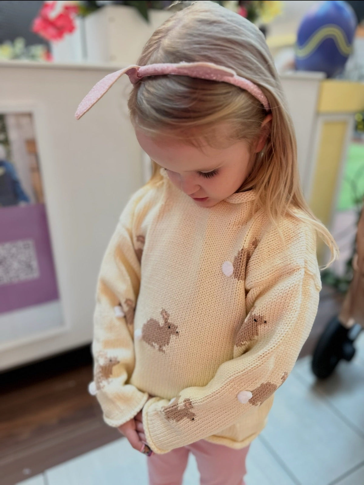 girl wearing ivory bunny sweater