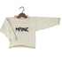 An off-white knit sweater with &