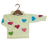 A cream-colored knit baby sweater with colorful knitted hearts in blue, pink, and green, displayed on a wooden hanger against a white background.