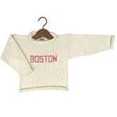 An off-white knit crewneck sweater with &