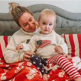 woman wearing ivory american flag sweater and daughter is wearing the kids version of the sweater