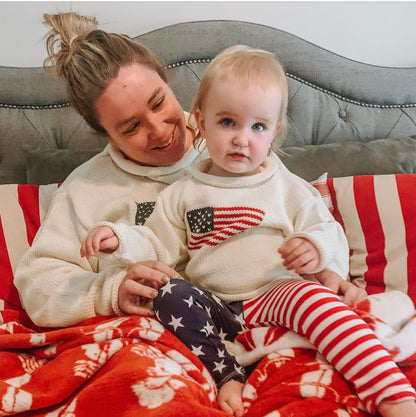 woman wearing ivory american flag sweater and daughter is wearing the kids version of the sweater