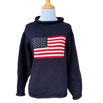 A navy blue chunky knit cotton sweater with a red and white striped roll neck featuring a knitted American flag design.
