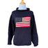 A navy blue chunky knit cotton sweater with a red and white striped roll neck featuring a knitted American flag design.