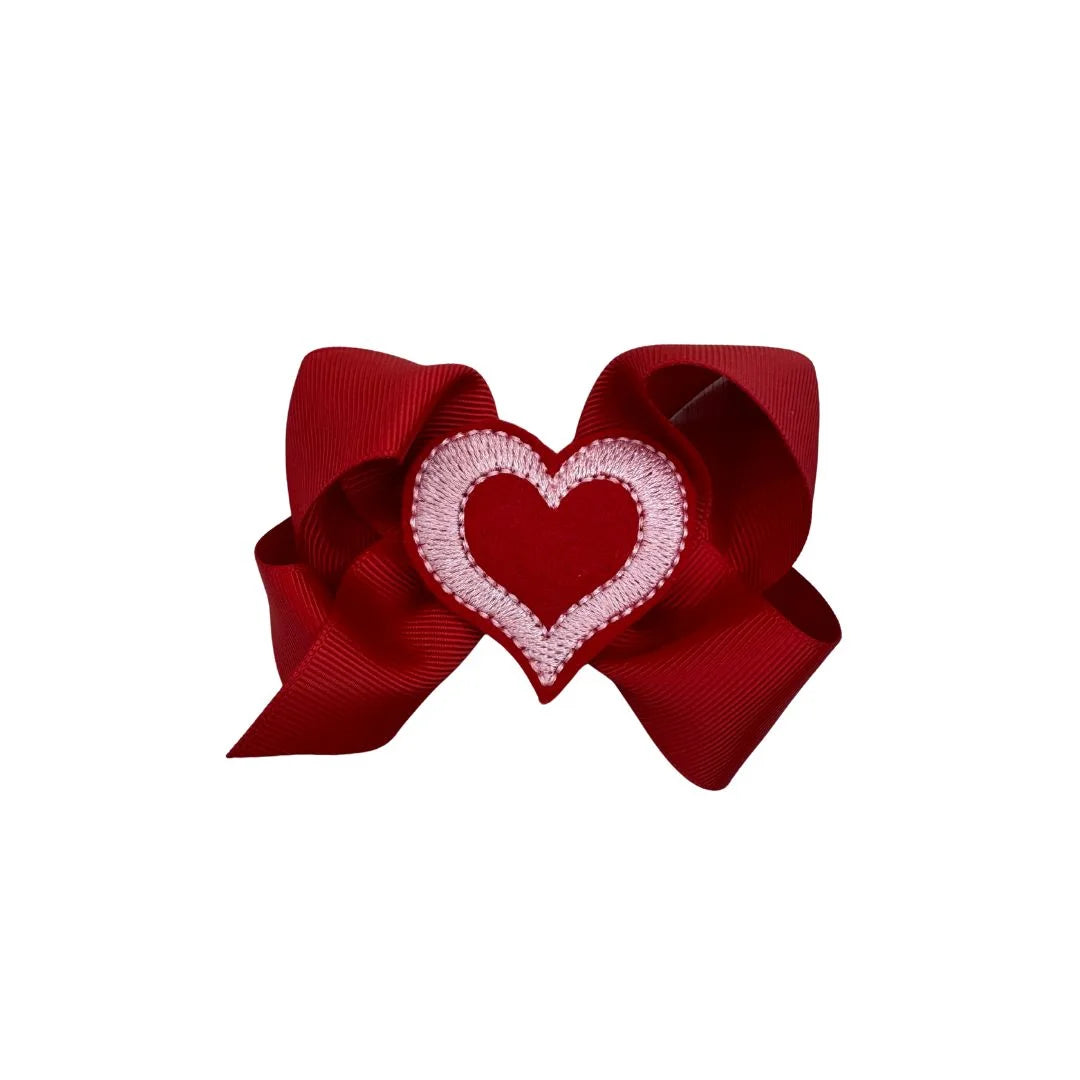 Red bow with a heart design on a white background
