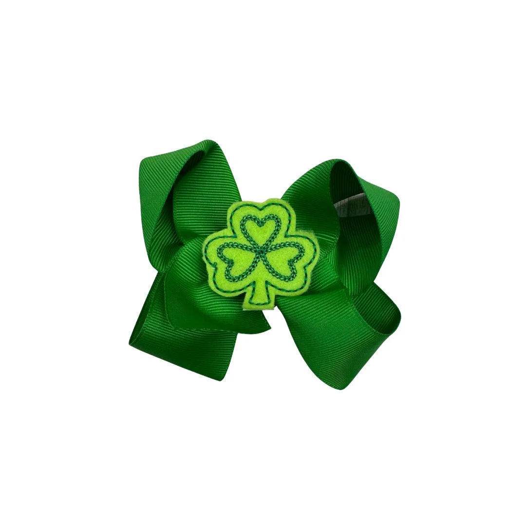 Green hair bow with a shamrock design on a white background