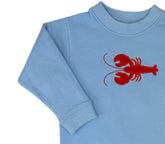 Light blue sweater with a red lobster design on a white background