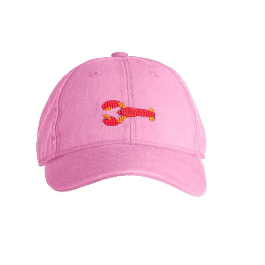 Pink cap with a small embroidered design on a white background