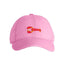 Pink cap with a small embroidered design on a white background