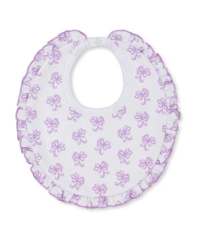 white bib with lilac bows all over and ruffle trim