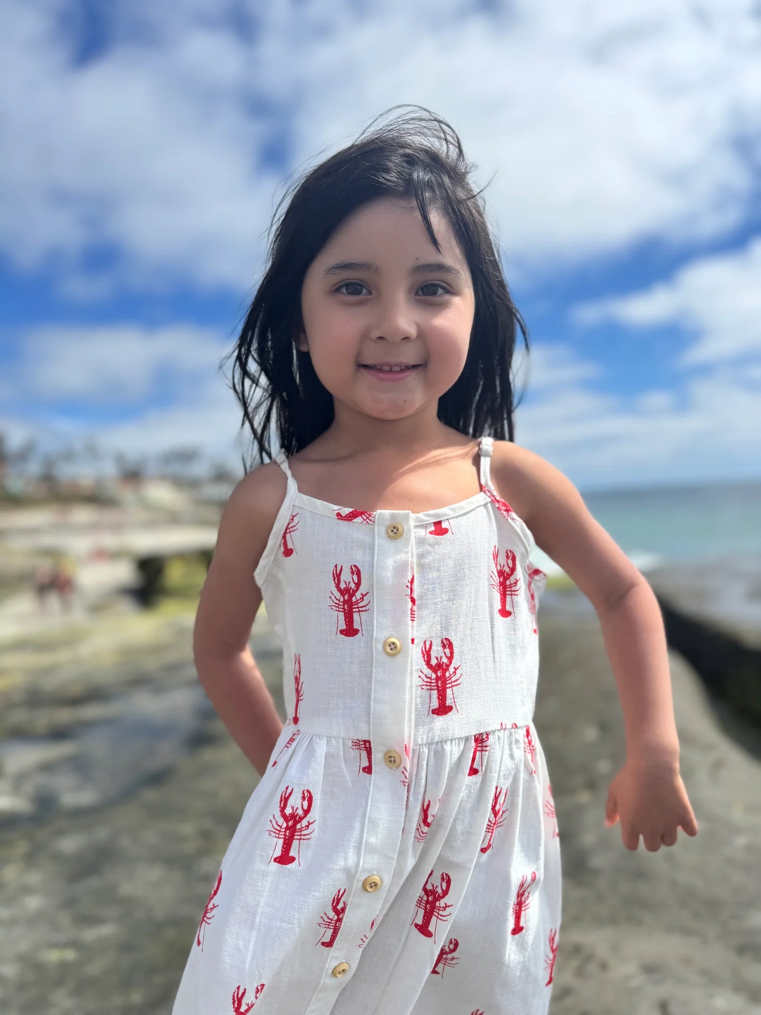 girl on the beach wearing lobster dress