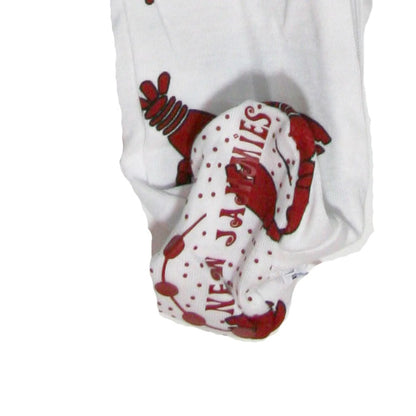 White baby booties with a red lobster and polka dot pattern, featuring the text &