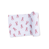 Folded fabric with red lobster pattern on a white background