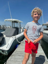 boy wearing the shirt on a dock