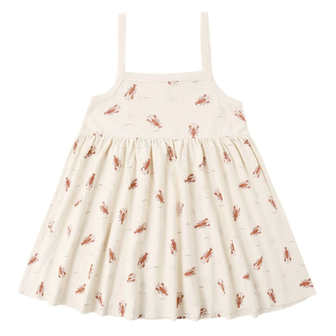 White dress with red lobster pattern on a white background