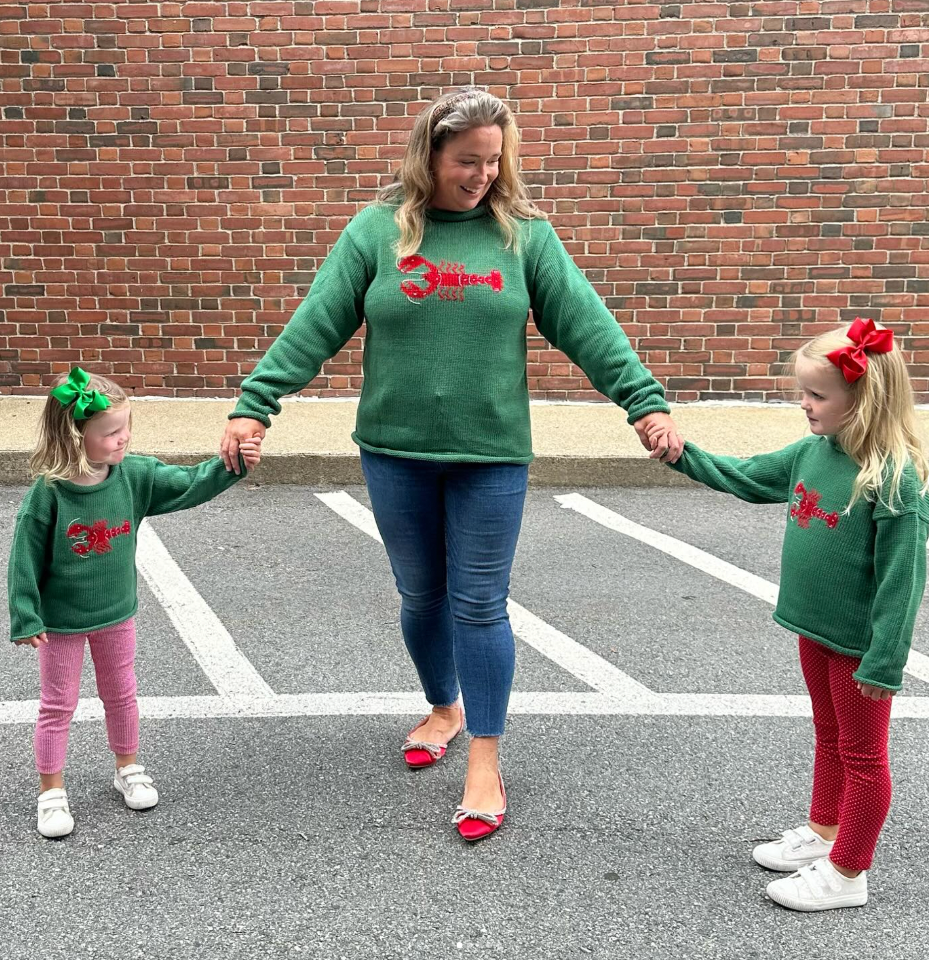 mom and daughters wearing the sweaters