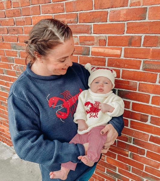 mom wearing navy lobster sweater and daughter is wearing ivory lobster sweater