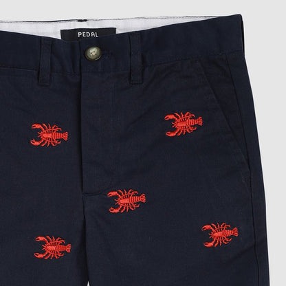 Navy shorts with red lobster embroidery on a white background