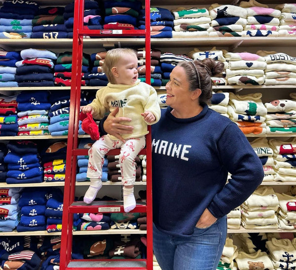 woman wearing the navy maine sweater and baby is wearing maine sweater