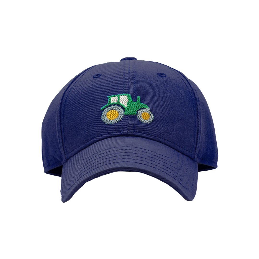 Navy blue cap with a green tractor emblem on a white background