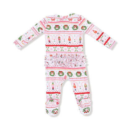 Christmas-themed baby onesie with festive patterns on a white background