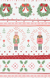 Christmas-themed fabric pattern with wreaths, nutcrackers, and holly leaves on a white background.