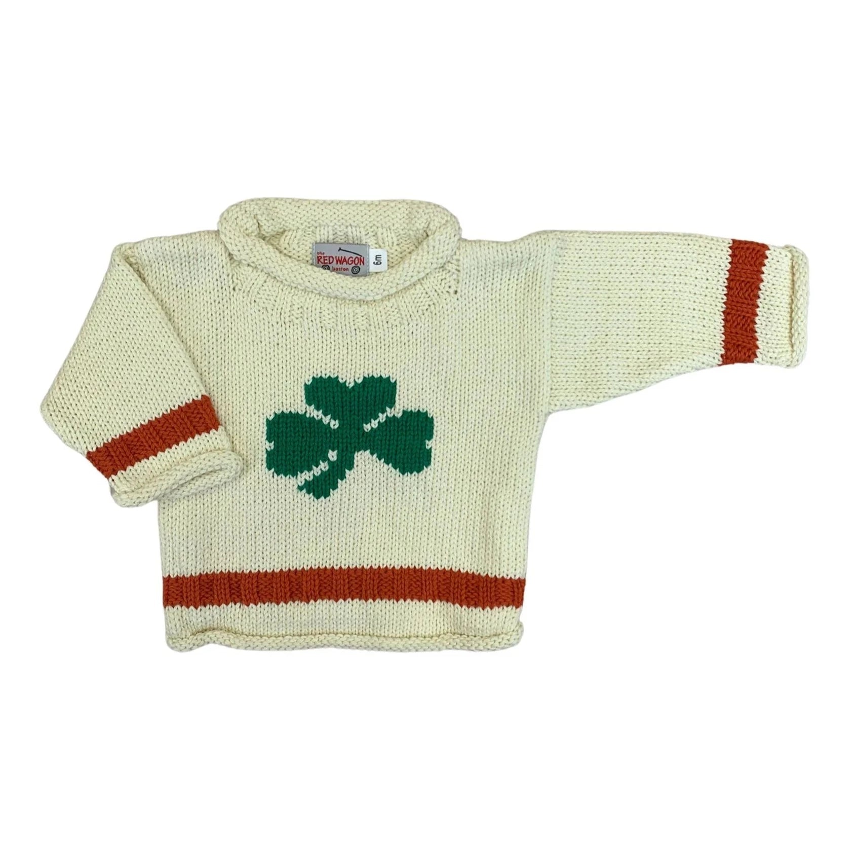 ivory long sleeve sweater with single green shamrock in center, orange stripe on each wrist and one stripe at bottom