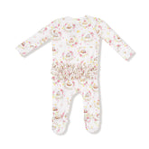 Floral patterned baby onesie with ruffle details on a white background