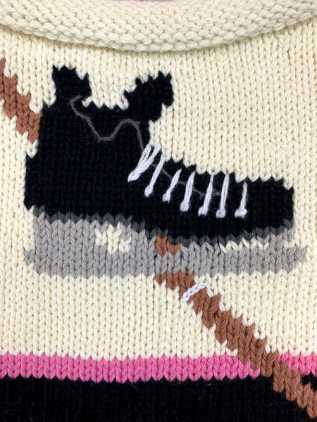 ivory long sleeve sweater with hockey skate and stick with pink and black stripe on waist and each sleeve