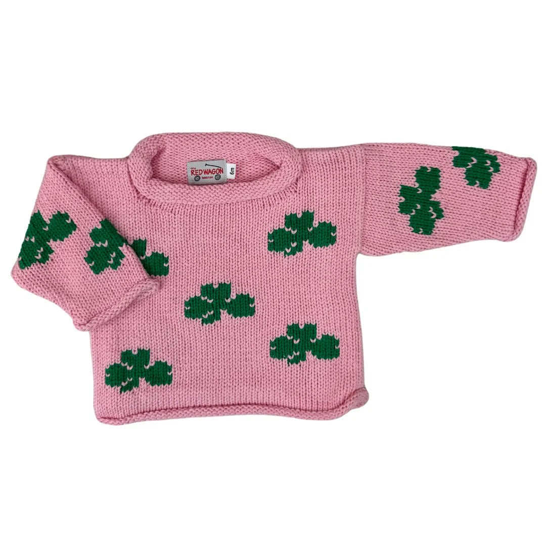 pink roll neck sweater with green shamrocks knitted all over
