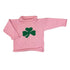 Pink knitted sweater with a green four-leaf clover design on a white background