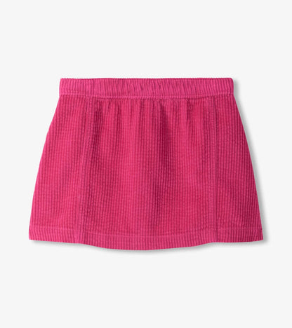 A bright pink textured skirt with an elastic waistband, shown flat against a light gray background.