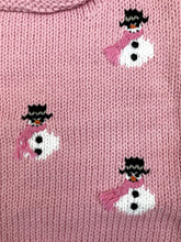 pink sweater with snowmen wearing hats and scarves all over