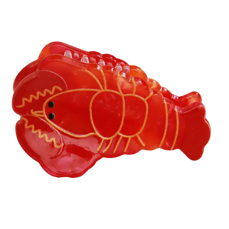 Red lobster-shaped hair clip on a white background