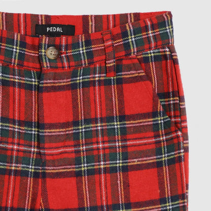 Red plaid pants with a visible brand label on a light gray background